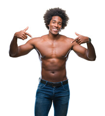 Fototapeta premium Afro american shirtless man showing nude body over isolated background looking confident with smile on face, pointing oneself with fingers proud and happy.