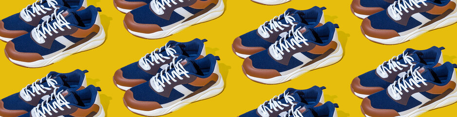 Sneakers shoes pattern on yellow background. Pair