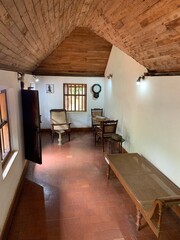 old traditional village house living room with clock and wooden chairs and table india