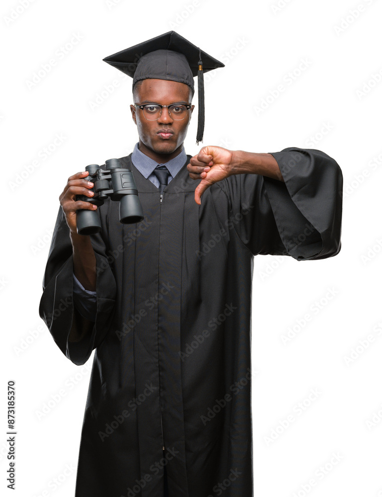 Wall mural Young graduated african american man looking for a job using binoculars with angry face, negative sign showing dislike with thumbs down, rejection concept