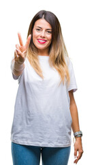 Young beautiful woman casual white t-shirt over isolated background showing and pointing up with fingers number two while smiling confident and happy.