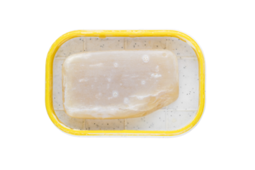 Piece of used soap in a soap dish isolated closeup