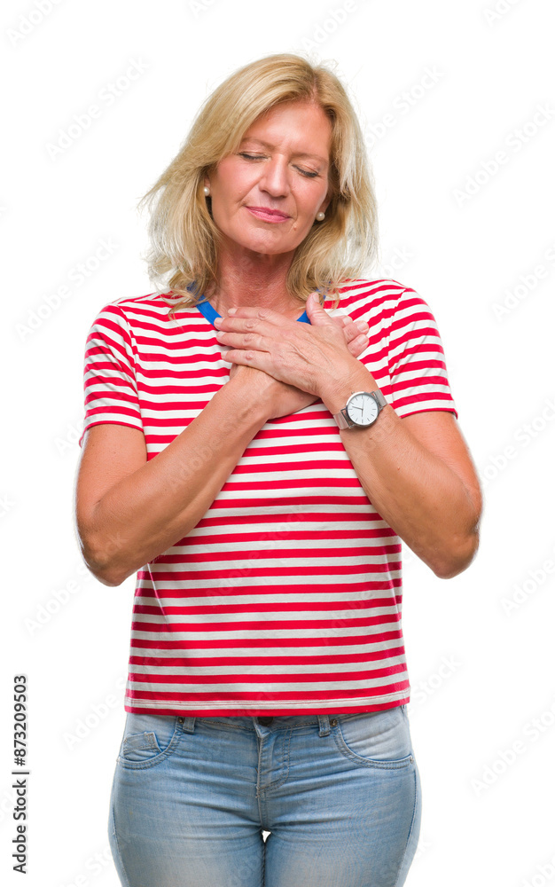 Wall mural middle age blonde woman over isolated background smiling with hands on chest with closed eyes and gr