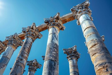 A row of ancient columns standing proud against a clear blue sky.