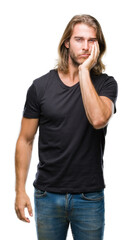 Young handsome man with long hair over isolated background thinking looking tired and bored with depression problems with crossed arms.