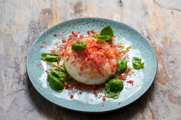 Burrata cheese with frozen tomato, basil and olive oil
