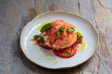 Burrata cheese with frozen tomato, basil and olive oil