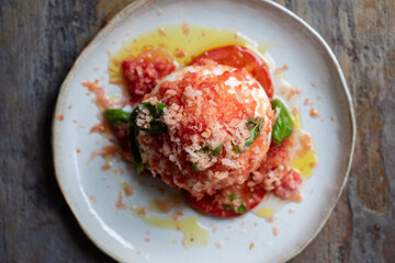 Burrata cheese with frozen tomato, basil and olive oil