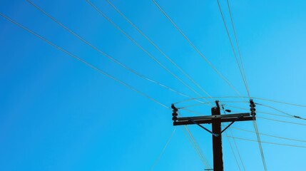 Bird s eye view of power pole and overhead power line against the sky with room for text