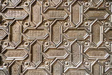Background of ordered metal geometric elements with patterns and oriental script
