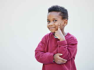 Studio, thinking and black child with smile, preschool and smart boy with knowledge, idea and planning. White background, learning and education for kid, growth and development of brain in Nigeria
