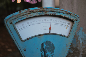 Blue old vintage scale outside in a cozy courtyard