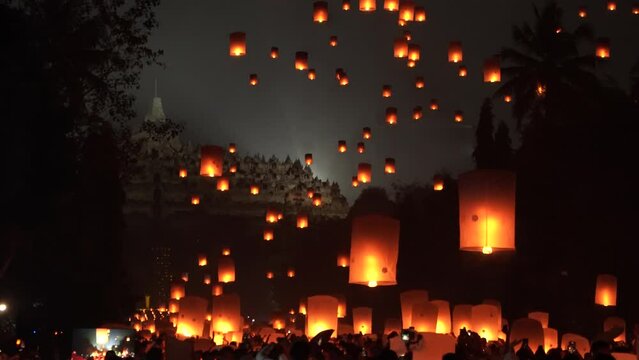 Indonesian people gathering together to release lantern during buddhism Vaisak Day celebration at Borobudur Temple.