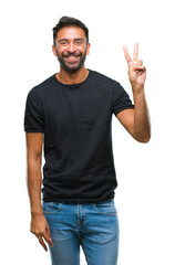 Naklejka premium Adult hispanic man over isolated background smiling with happy face winking at the camera doing victory sign. Number two.