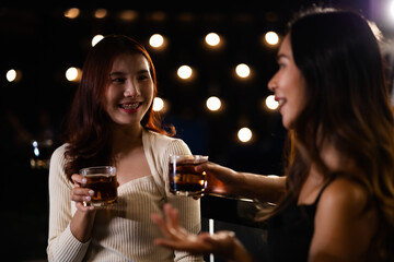 Two women at a nightclub Drink alcohol, talk, party, dance together happily.