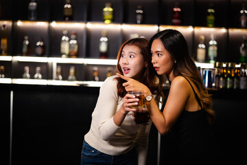 Two women at a nightclub Drink alcohol, talk, party, dance together happily.