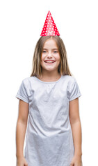 Young beautiful girl wearing birthday cap over isolated background with a happy and cool smile on face. Lucky person.