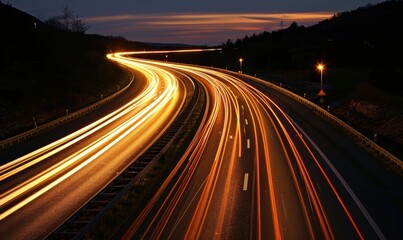A highway with a long, curving road and many cars on it