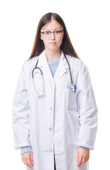 Fototapeta premium Young Chinese doctor woman over isolated background with serious expression on face. Simple and natural looking at the camera.