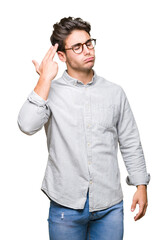 Fototapeta premium Young handsome man wearing glasses over isolated background Shooting and killing oneself pointing hand and fingers to head, suicide gesture.