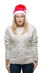 Young caucasian woman wearing christmas hat over isolated background afraid and shocked with surprise expression, fear and excited face.