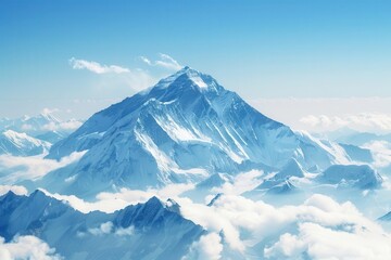 majestic snowcapped mountain peak rising above clouds isolated against a crisp blue sky sunlight creates dramatic shadows on the rugged terrain