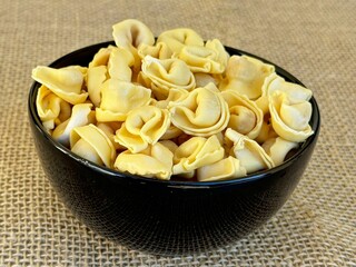 Italian tortellini (capeletti, agnolini) pasta in a bowl. Soup. Soup.