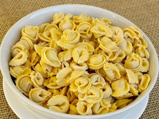 Italian tortellini (capeletti, agnolini) pasta in a bowl. Soup.