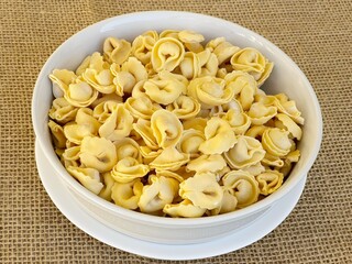 Italian tortellini (capeletti, agnolini) pasta in a bowl. Soup.