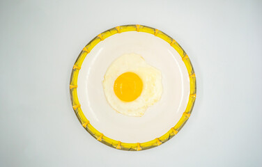 A fried poached egg with yellow poached egg on a plate ready to eat delicious