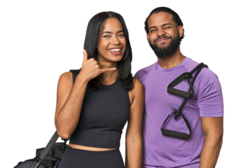 Young Latino couple ready for gym training showing a mobile phone call gesture with fingers.