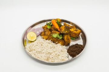 Delicious Flaky Rice and Fried Chicken Spicy Nepali masu chiura lunch on a plate chicken curry fried