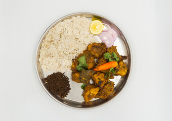 Delicious Flaky Rice and Fried Chicken Spicy Nepali masu chiura lunch on a plate chicken curry fried