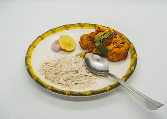 Delicious Flaky Rice and Fried Chicken Spicy Nepali masu chiura lunch on a plate chicken curry fried