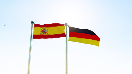 Germany and Spain Flags are waving in the spring of the blue sky. 4K ULTRA HD. 