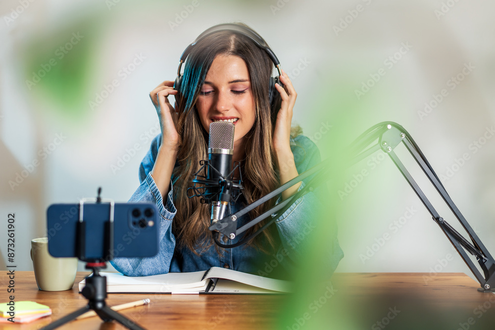 Wall mural happy woman recording podcast with microphone and headphones - new works lifestyle