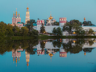 Naklejka premium View of the Novodevichy convent in Moscow. Landscape with monastery reflecting in lake