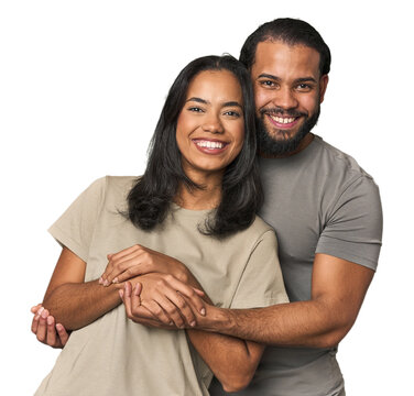 Latino couple in love embracing warmly in studio