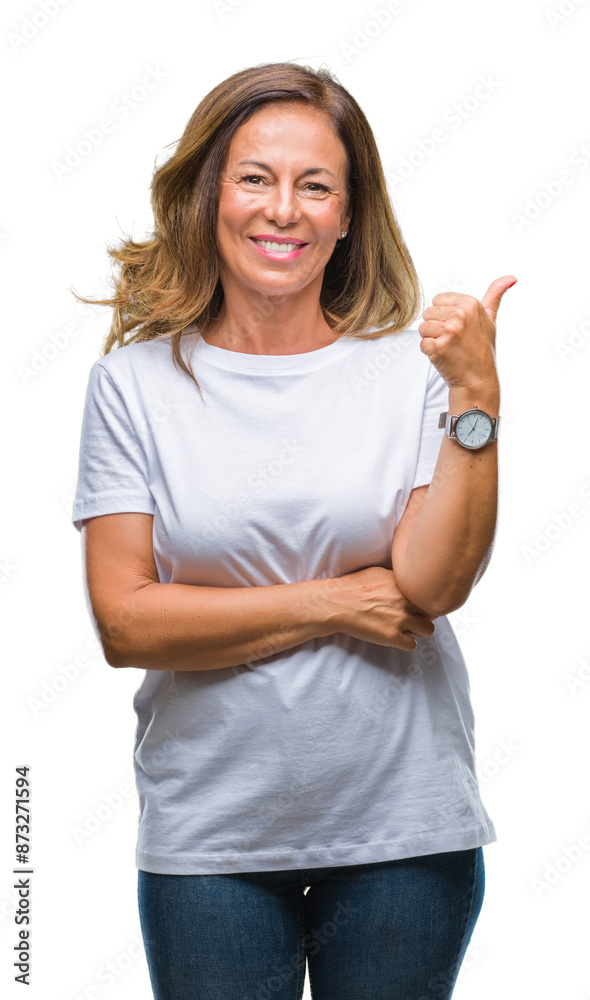 Wall mural middle age senior hispanic woman over isolated background smiling with happy face looking and pointi