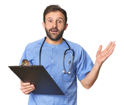 Hispanic male nurse with inventory receiving a pleasant surprise, excited and raising hands. - Powered by Adobe