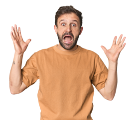 Studio portrait of young Hispanic male screaming to the sky, looking up, frustrated.