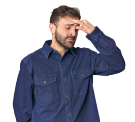 Studio portrait of young Hispanic male having a head ache, touching front of the face.