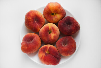 Flat peaches on a white background. Peaches in a package.