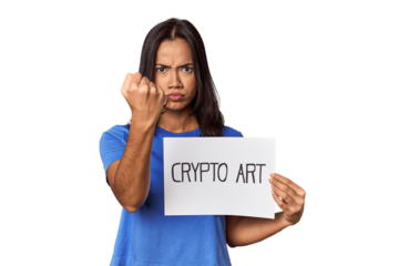 Woman with "crypto art" sign in studio showing fist to camera, aggressive facial expression.