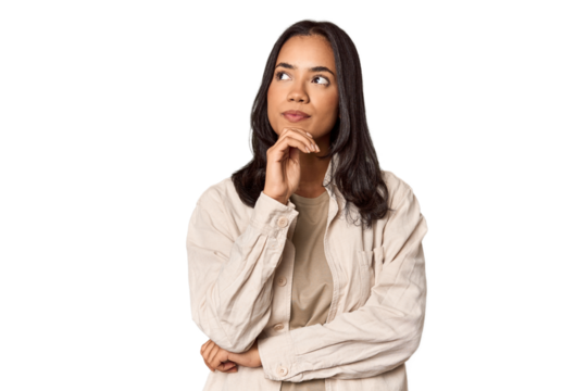 Portrait of a young Filipino woman looking sideways with doubtful and skeptical expression.