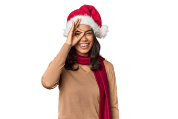 Filipino in Christmas attire and Santa hat excited keeping ok gesture on eye.