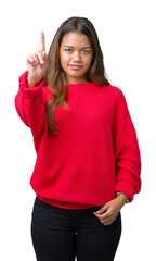 Young beautiful brunette woman wearing red winter sweater over isolated background Pointing with finger up and angry expression