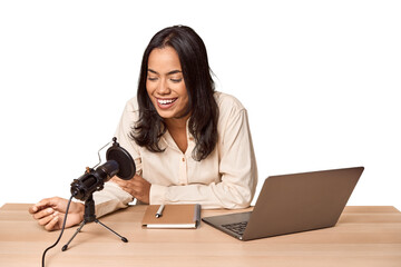 Filipino woman podcasting with mic and laptop