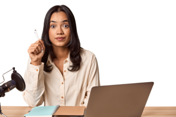 Filipino woman podcasting with mic and laptop