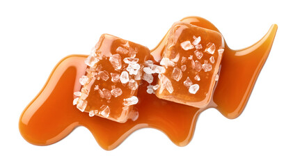 Two salty or salted caramel candy cubes topped with caramel sauce and sea salt on white background